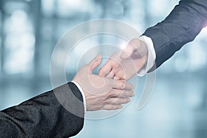 Businessmen reach out to each other to shake hands