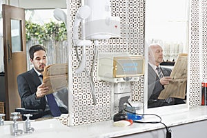 Businessmen Reading Newspapers In Hair Salon