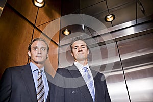 Businessmen riding in elevator