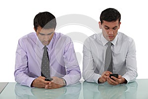 Businessmen sending text messages