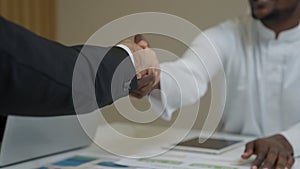 Businessmen shacking hands together showing successful contract agreement