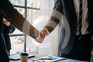 Businessmen shake hands after agreeing to start a new project successfully