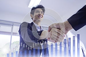Businessmen shake hands with investors to show that business deals have been reached, showing financial data, sales rates, market