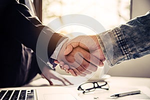 Businessmen shake hands with successful partners and congratulate