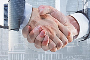 Businessmen shaking hands on blurry city background