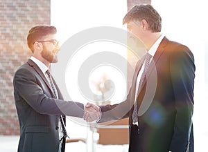 Businessmen shaking hands on business meeting in office