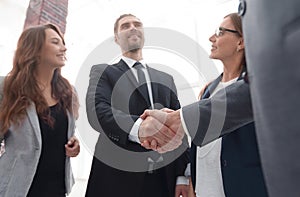 Businessmen shaking hands in conference room