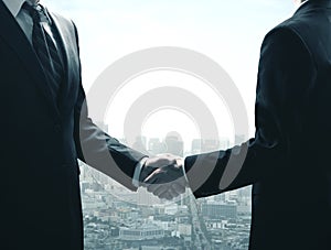 Businessmen shaking hands on modern city background