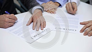 Businessmen signing a contract