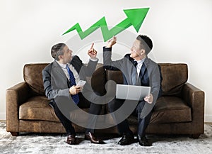 Businessmen sitting together with profit progressing icons
