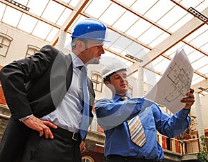 Businessmen Studying Blueprint photo