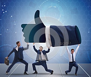 Businessmen supporting thumbs up gesture