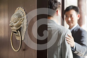 Businessmen Talking Behind Open Door