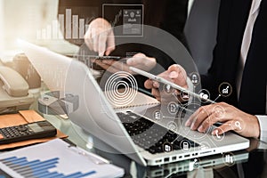 Businessmen team or financial data analysts working with tablets and laptop computers and data graphs.