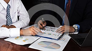 businessmen team meeting to plan strategies to increase business income. Have a brainstorming graph analysis and discussing for