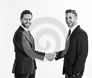 Businessmen with unshaven smiling faces shaking hands.