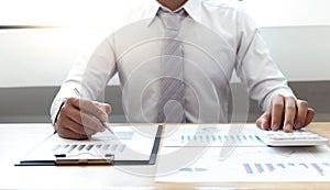 Businessmen use graphs to summarize results and calculate income-expenses to find financial balance points and use them to improve