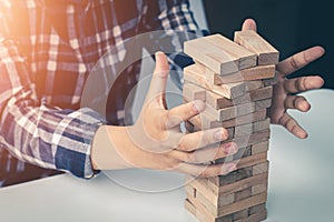 Businessmen use the hands to prevent falling Domino. To maintain the remaining benefits do not fall