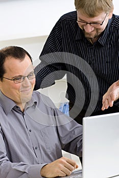 Businessmen using laptop computer