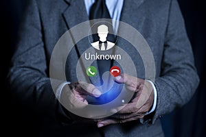 Businessmen using smartphone with incoming call from unknown number, Call center gang, Prank caller, scammer or stranger photo