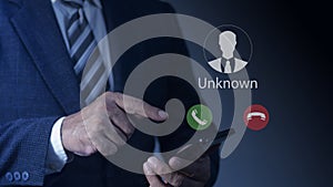 Businessmen using smartphone with incoming call from unknown number, Call center gang, Prank caller, scammer or stranger photo