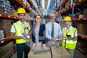 Businessmen and warehouse workers