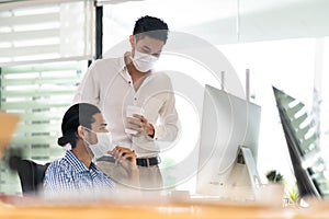 Businessmen wear face mask dicuss in new normal office