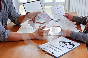 Businessmen who are stressed due to bankruptcy and are tearing the contract in front of the lawyer in the lawyer office photo