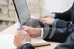 Businessmen during work with computer, note, pen,financial work