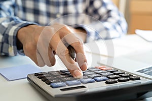 Businessmen work by using a calculator to calculate expense accounts. The concept of numbers and finance.
