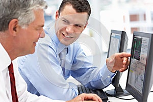 Businessmen working on computers