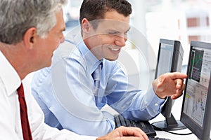 Businessmen working on computers