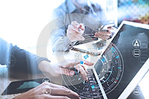 Businessmen working together on a document and using smart phone