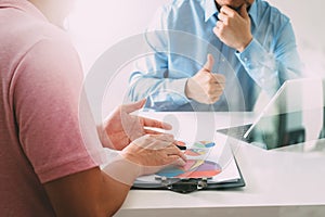 Businessmen working together on a document and using smart phone