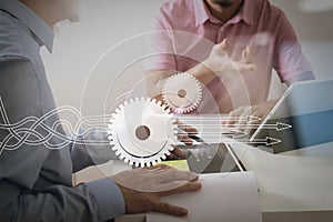 Businessmen working together on a document and using smart phone