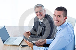 Businessmen working together with laptop and tablet