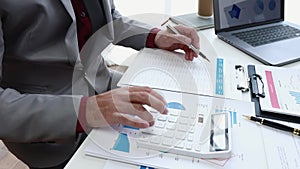 Businesspeople or accountant using calculator and laptop for calculating finance on desk office. business financial