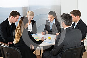 Businesspeople analyzing graph in office