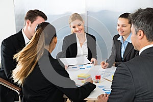 Businesspeople analyzing graph in office