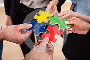 Businesspeople assembling jigsaw puzzle