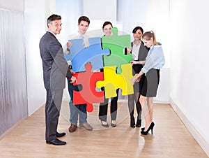 Businesspeople Assembling Jigsaw Puzzle