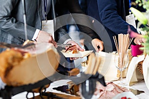 Businesspeople at banquet lunch break at business conference meeting. Assortment of food and drinks.