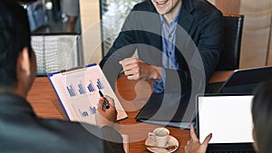 Businesspeople brainstorming and discussing business ideas together in meeting room.