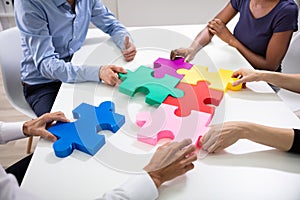 Businesspeople Building Colorful Jig Saw Puzzles Together