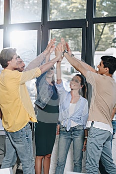 businesspeople celebrating success and giving high five