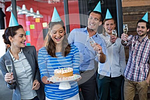 Businesspeople celebrating their colleagues birthday