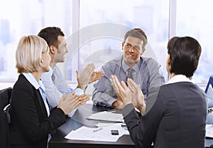 Businesspeople clapping hands