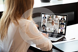 Businesspeople communicating using application webcam laptop view over businesswoman shoulder