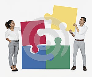 Businesspeople connecting jigsaw puzzle pieces