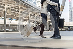 Businesspeople couple lover walking with luggage in business trip. Honeymoon business trip hug together on boarding arrival